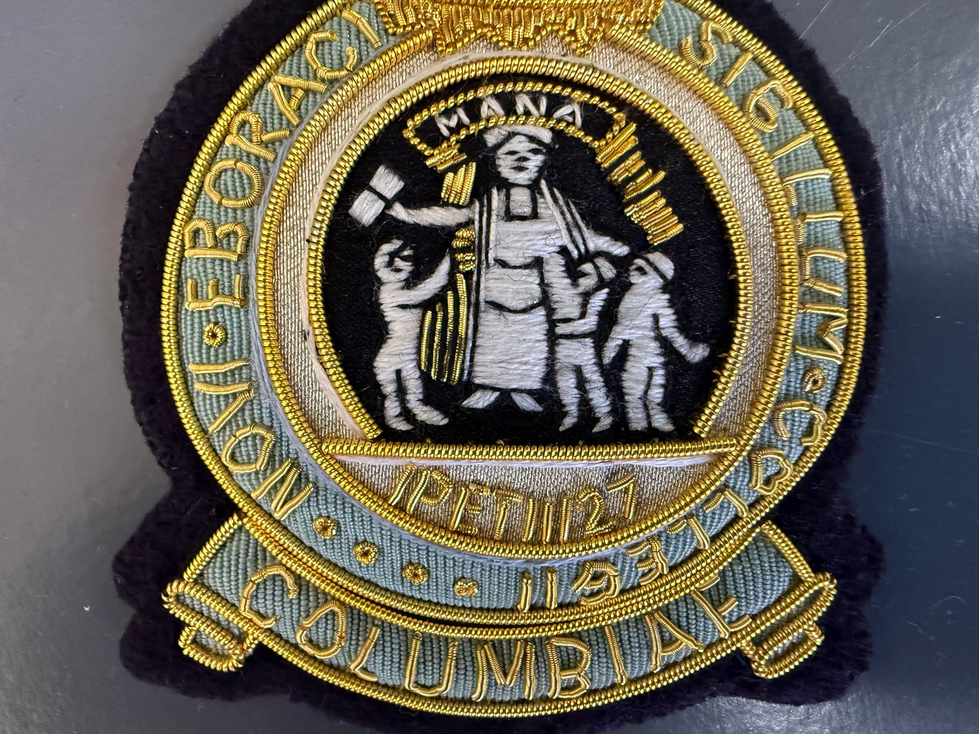 Custom Columbia University Embroidered patch with classical design and text on a dark background