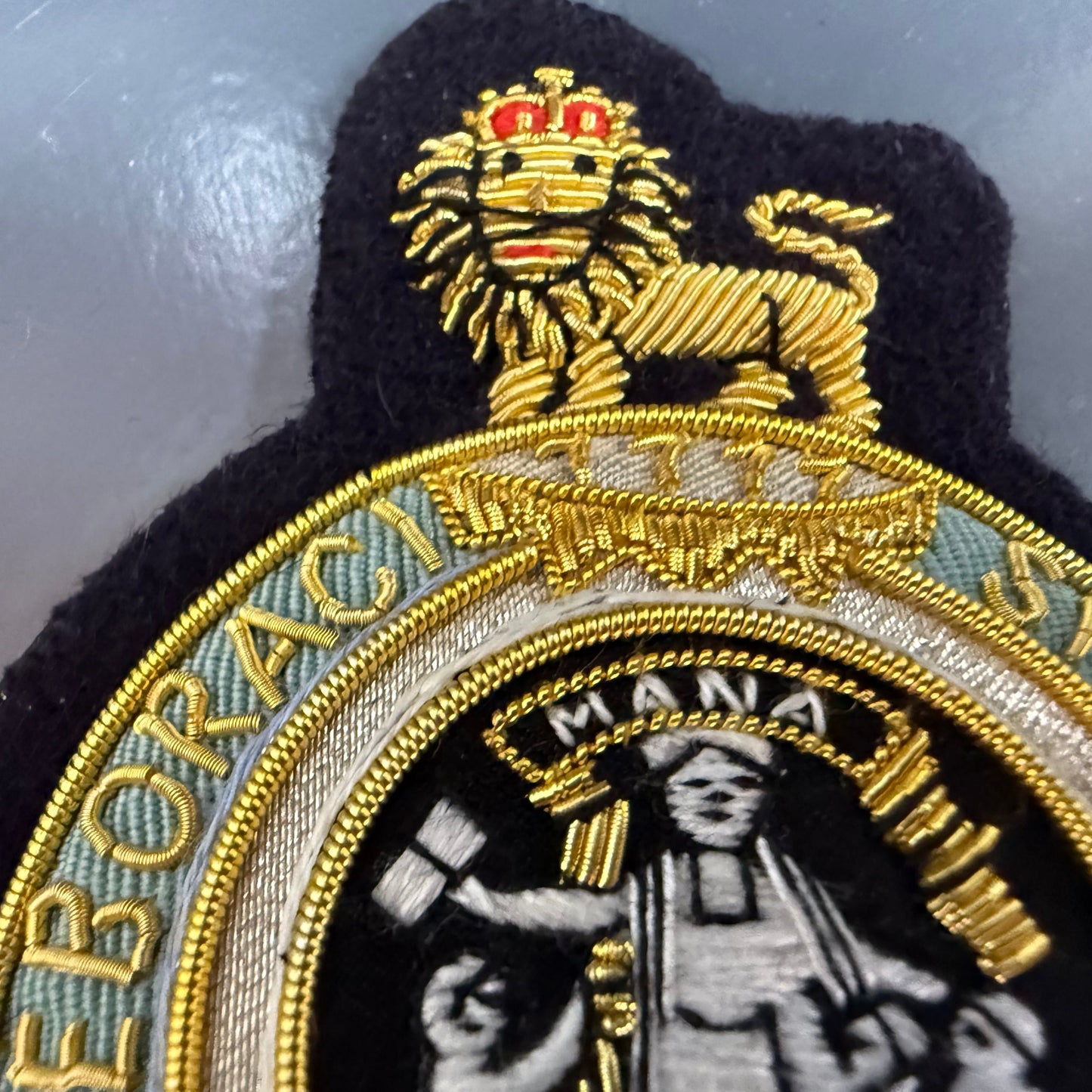 Embroidered blazer patch Columbia University with lion emblem and text on a metallic surface
