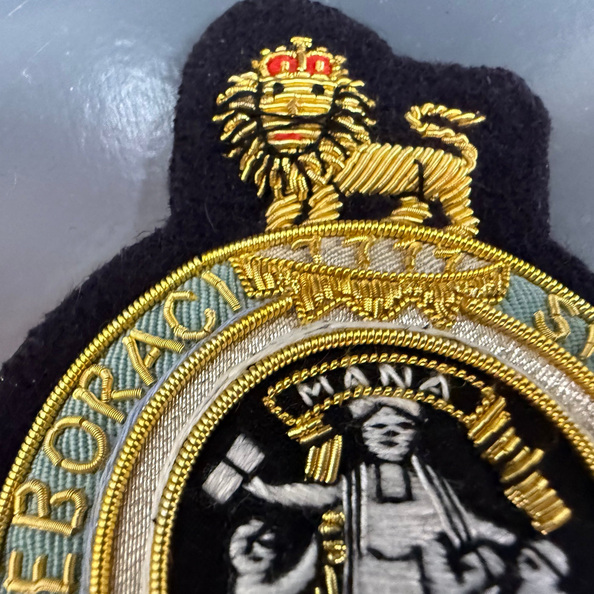 Embroidered blazer patch Columbia University with lion emblem and text on a metallic surface